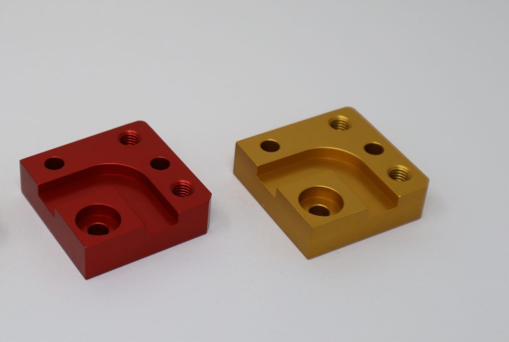 example of CNC milled parts treated in red and gold anodizing by meviy