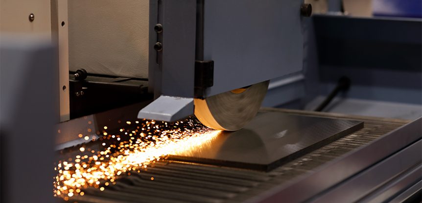 example of surface grinding being operated on a mechanical part